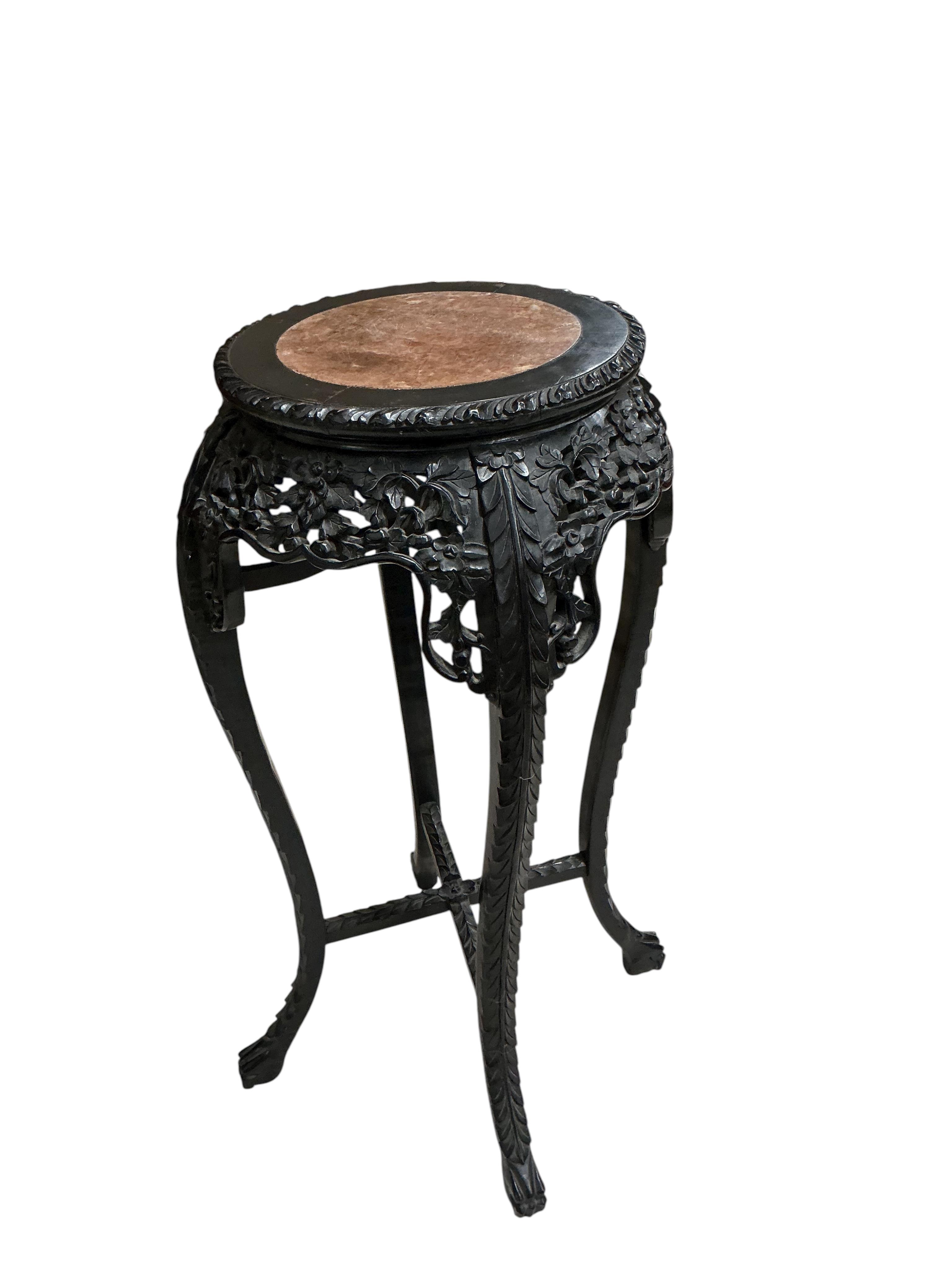 A Chinese circular rouge marble topped carved hardwood vase stand, diameter 44cm, height 91cm